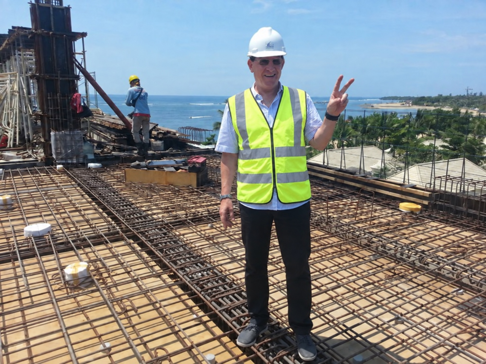 Bert on a construction site wearing a hardhat and high-visibility vest